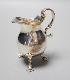 A George V silver cream jug, on tripod feet, William Comyns & Sons Ltd, London, 1928, 10.2cm, 5oz.